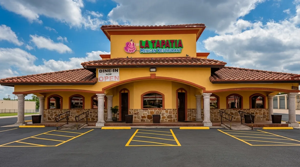 La Tapatia exterior at golden hour — yellow stucco, terracotta tiles, stone arches